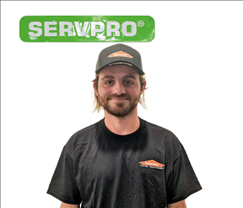 Cody Smith standing against a white background underneath a SERVPRO logo