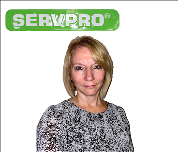 female employee with long hair under SERVPRO sign