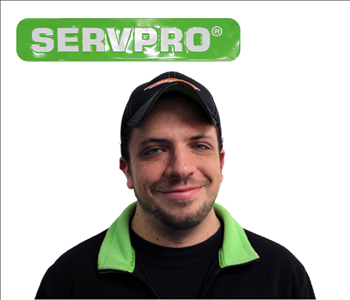 Jon Miller under SERVPRO sign for his employee Photo