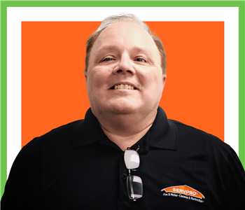 Bill Repsel for SERVPRO photo on white wall, male employee