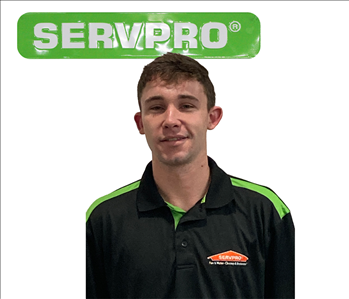 Kyle Workman, male, SERVPRO employee in front of green sign, white background